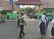 Melayani Sepenuh Hati, Personel Polres Lampung Utara Gatur Lalu Lintas dan Bantu Pelajar Menyeberang